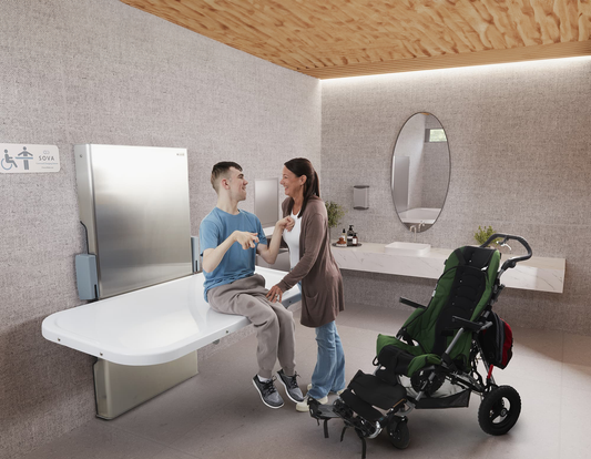 Mother with adult son with disabilities on an adult changing table