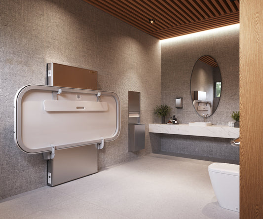 Ascent Adult Changing Table mounted to a public washroom wall.