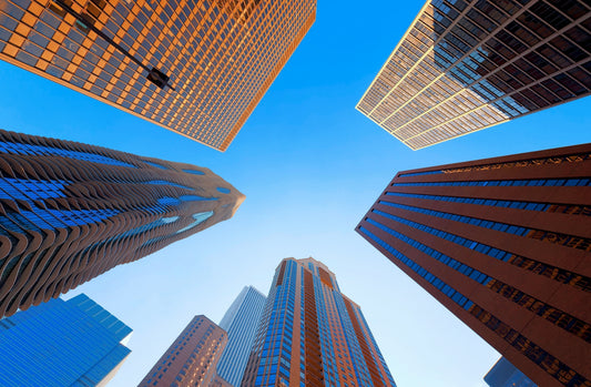 A view looking up at tall skyscraper buildings