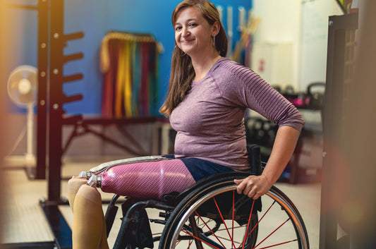 Woman in a wheelchair with a prosthetic leg.
