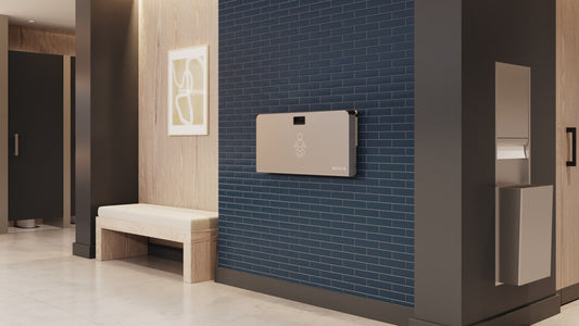 Summit Stainless Steel Baby Changing Station wall mounted in a public washroom setting.