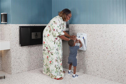 Woman and child interacting with a machine in a toddler wall seat