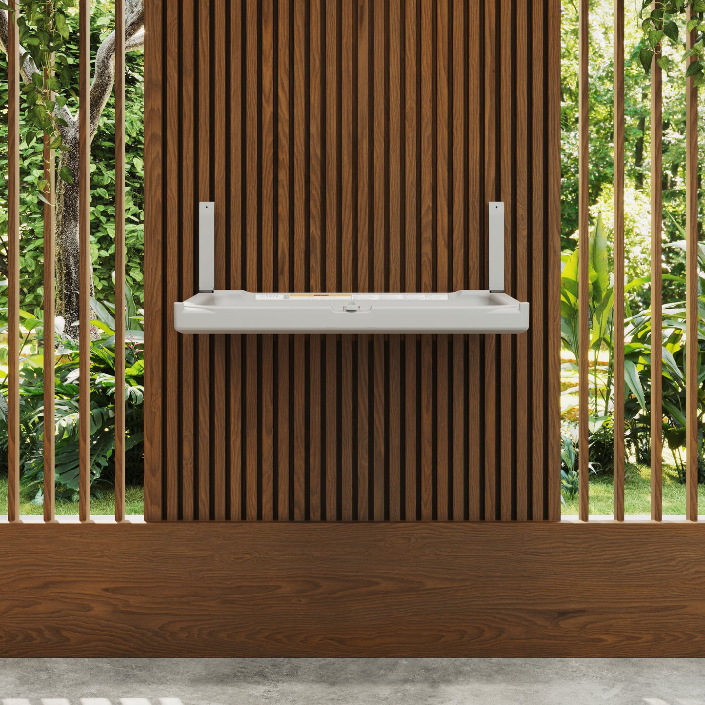 White Sova Element Baby Changing Station wooden slat wall with greenery in the background