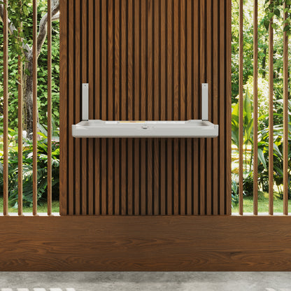 White Sova Element Baby Changing Station wooden slat wall with greenery in the background