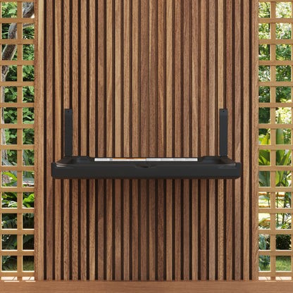 Black Sova Element Baby Changing Station against a wooden paneled wall with lattice windows.