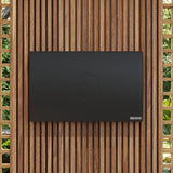 Black Sova Element baby changing station mounted on wooden wall