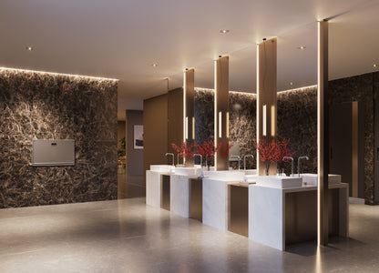 Modern bathroom with marble walls and a large mirror.