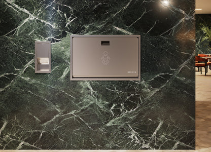 Sova Baby Changing Station with Liner Dispenser mounted on marble wall 