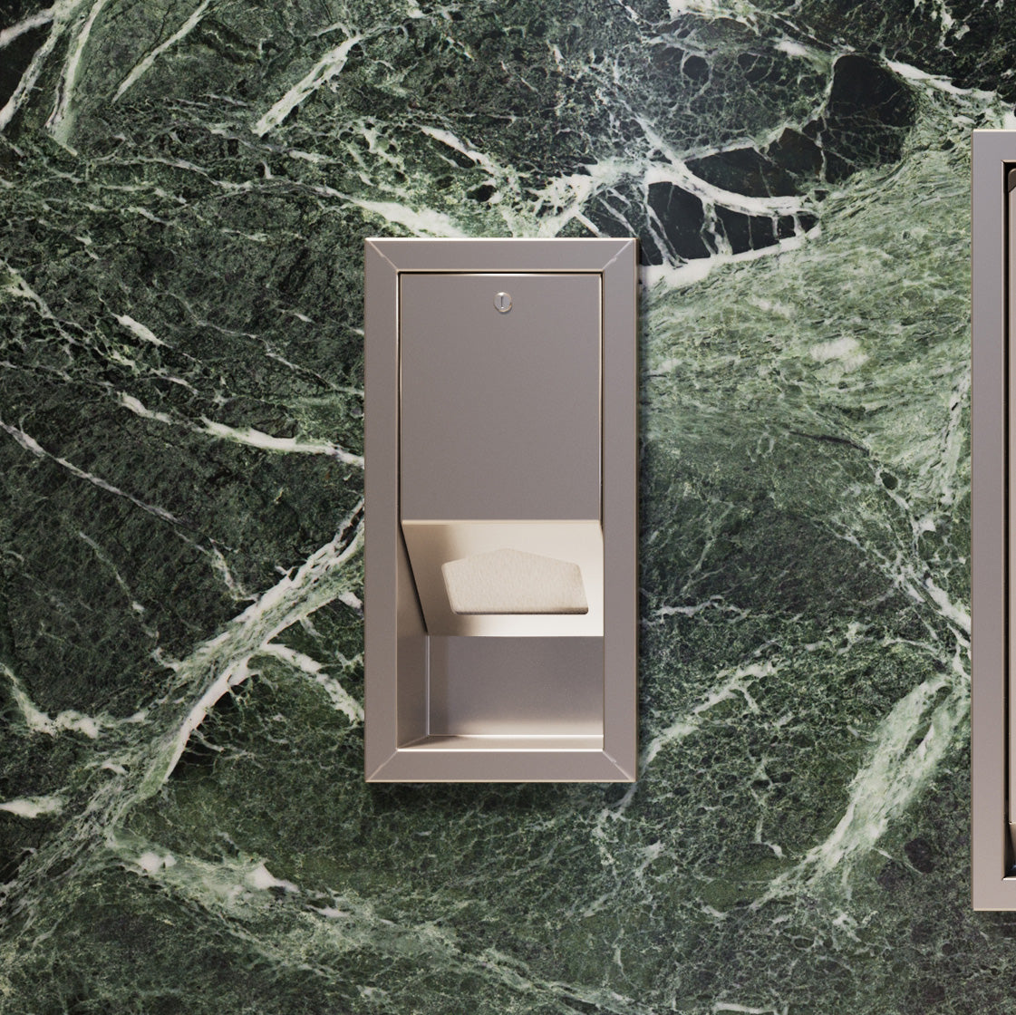 Wall-mounted Sova Liner Dispenser on green marble wall