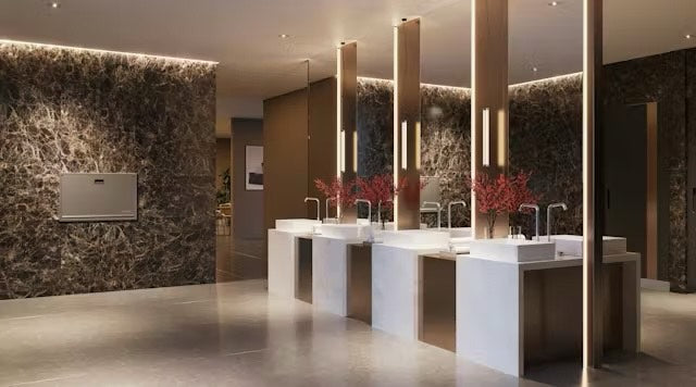 Modern bathroom with marble walls, sinks, and decorative elements.