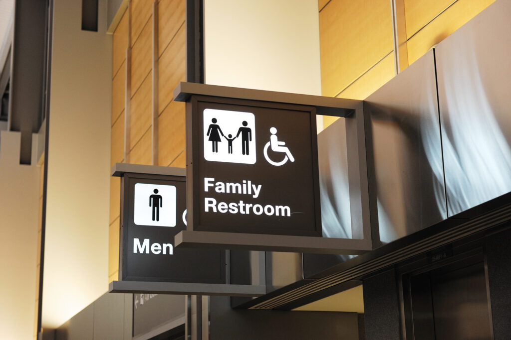 Family restroom sign with accessibility icon in a public building.